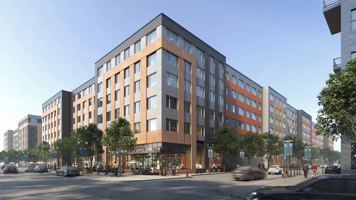 Six-story brown and grey apartment building with cars and street in the foreground.