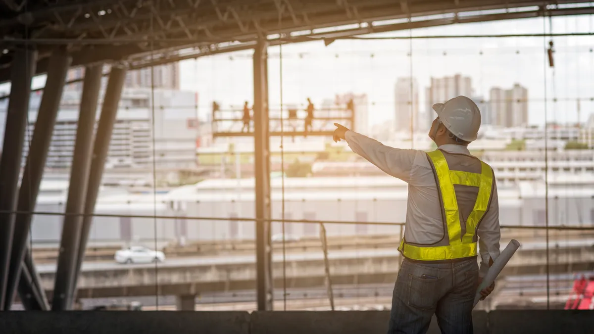 Senior engineer looking drawing on site construction of mass transits