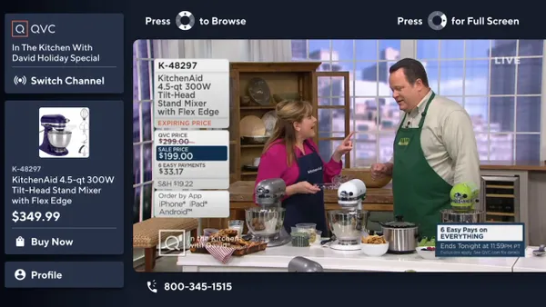 In a screenshot, two people demonstrate a kitchen stand mixer during a QVC segment