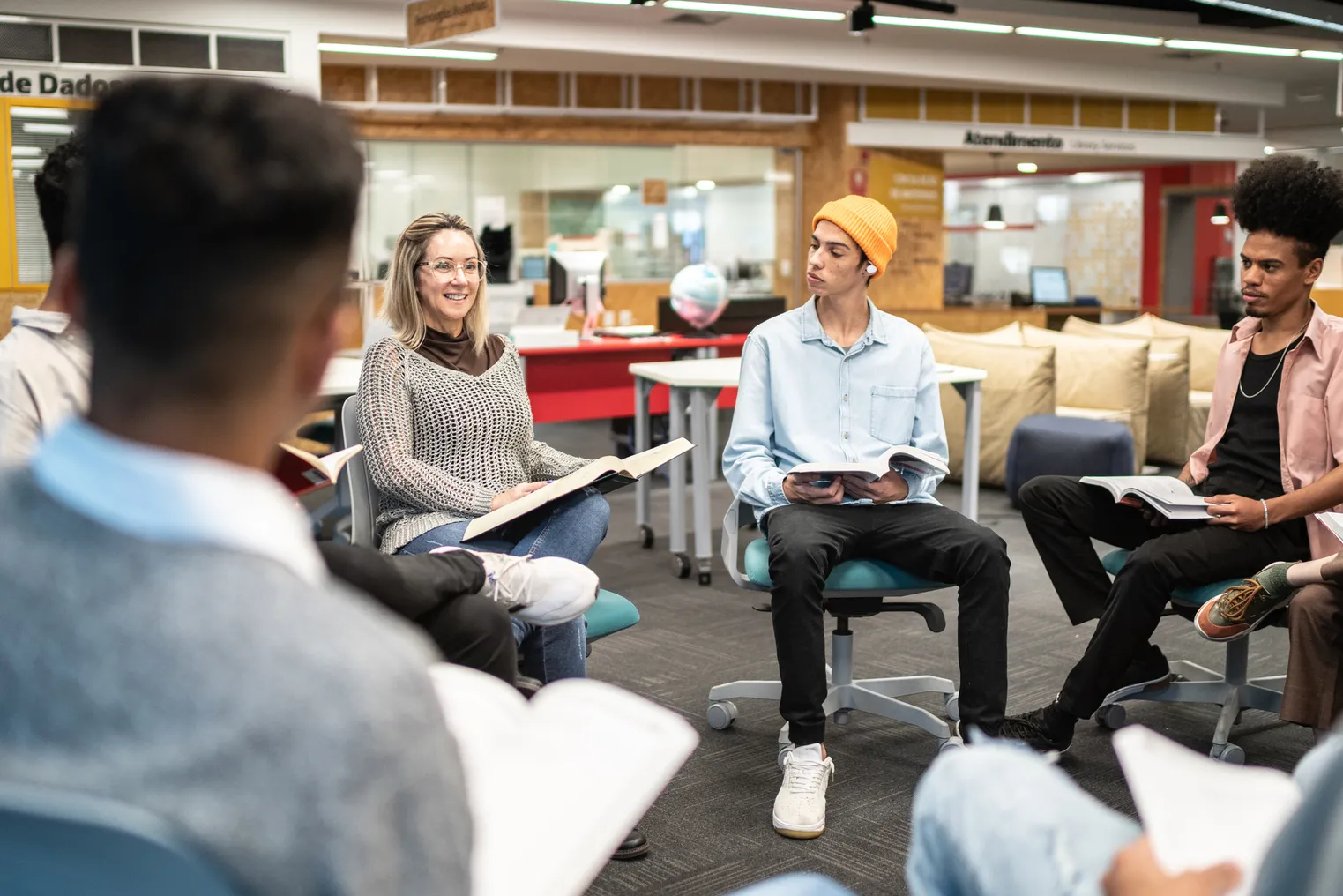 A group of employees sits in a circle and chats.