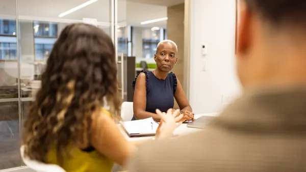 Three diverse professionals engaging in a focused discussion