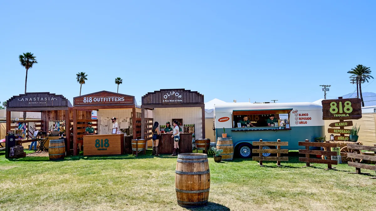 Several booths designed to like the old West are lined up outside.