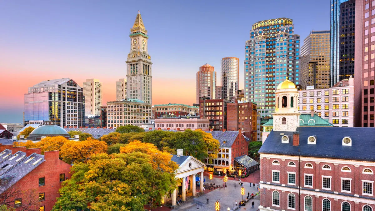 A picture of Boston's skyline and Quincy Market at dusk