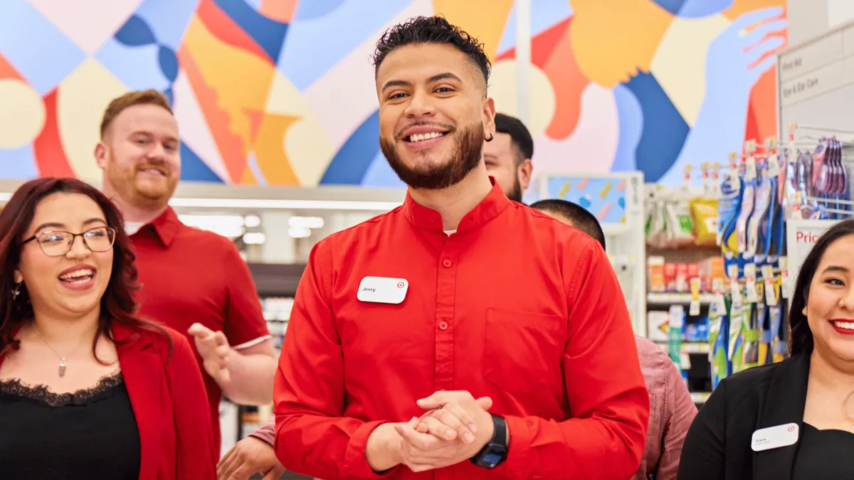 Target employees inside a store smile at the camera.