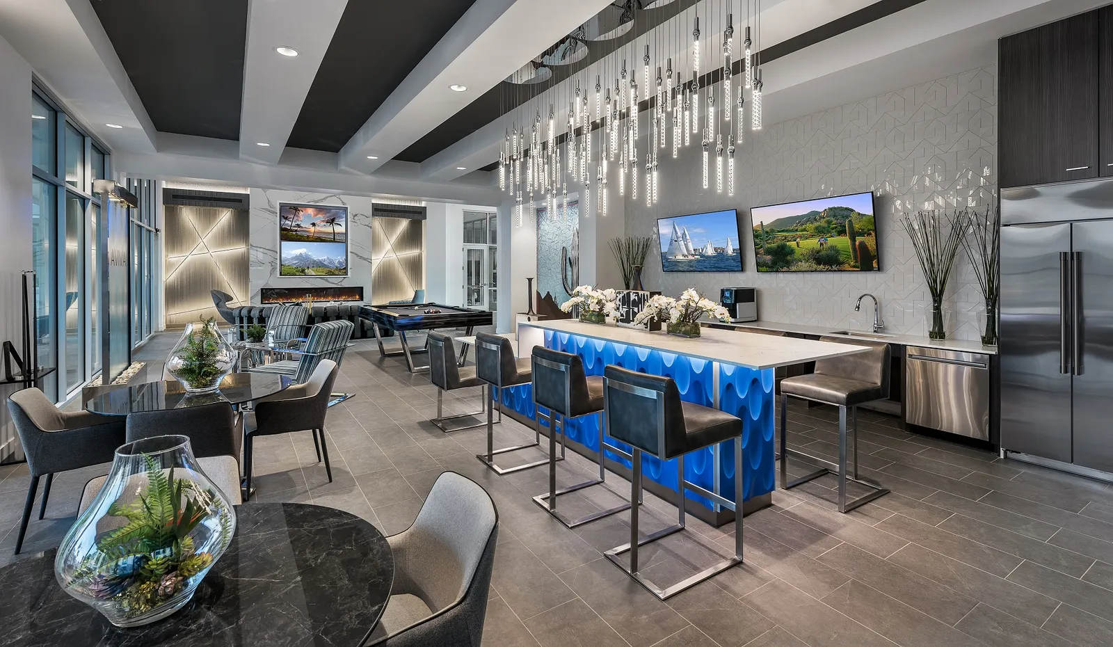 A lounge room and bar with steel gray and bright blue accents.