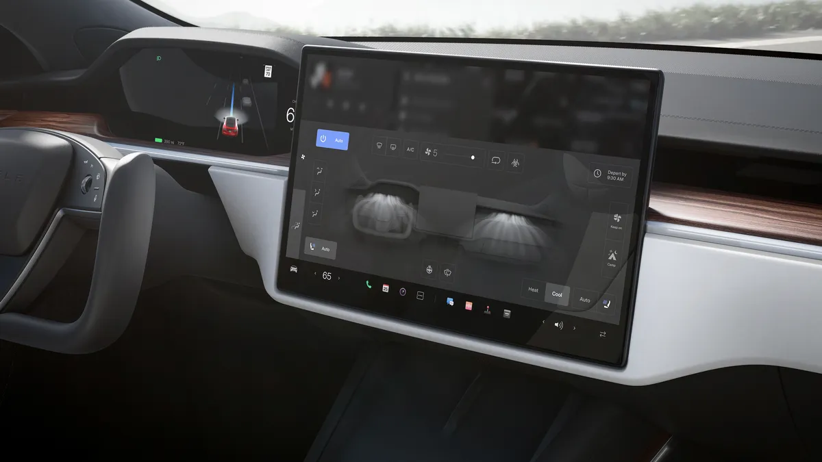 The interior of a Tesla Model S showing the center touchscreen display.