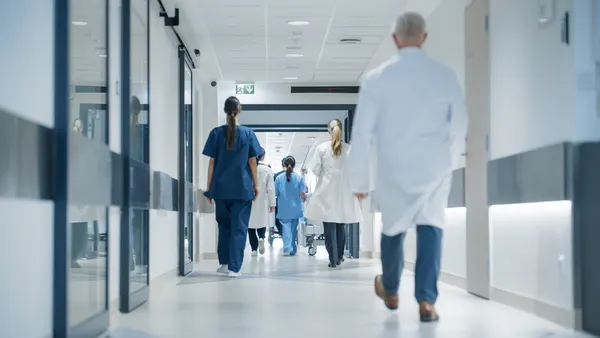 Hospital Hallway with Doctors, Nurses and Specialists in Hospital. F