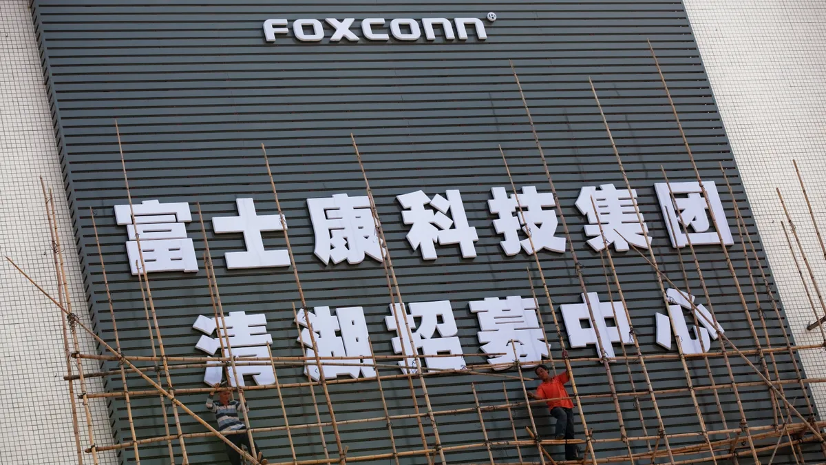 Workers put up scaffolding on a building owned by the contract manufacturer Foxconn International Holdings Ltd on November 28, 2010 in Shenzhen, China.