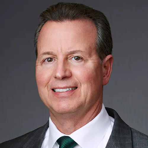 A headshot shows Tutor Perini executive Gary Smalley.