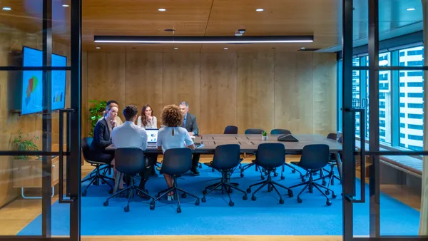 people meeting and working at a board room table