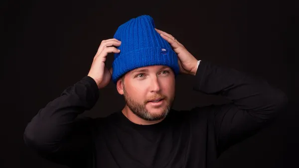 A man wearing a blue beanie from Love Your Melon