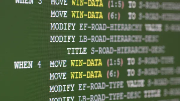 Image of a green computer screen with COBOL coding on it.