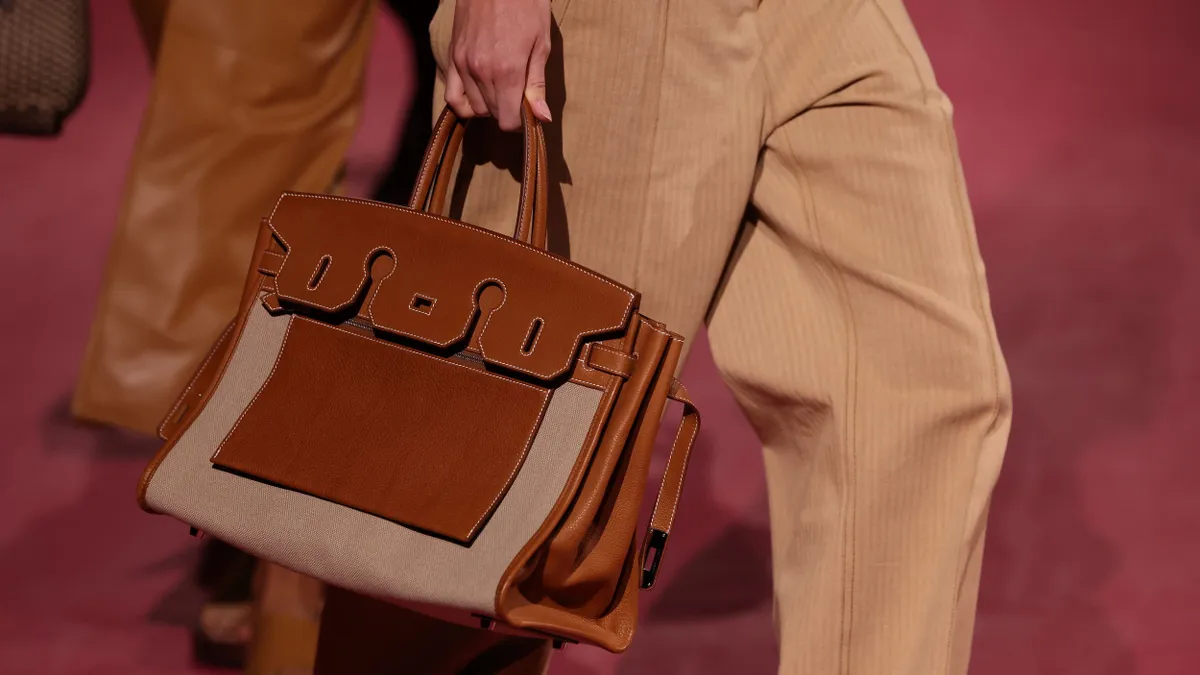 A closeup of a model's handbag on the runway.