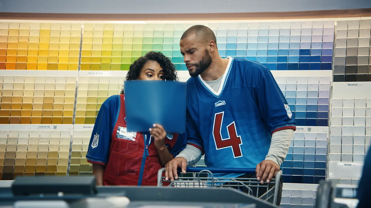 Dallas Cowboys quarterback Dak Prescott stands in the pain aisle in a Lowe's commercial