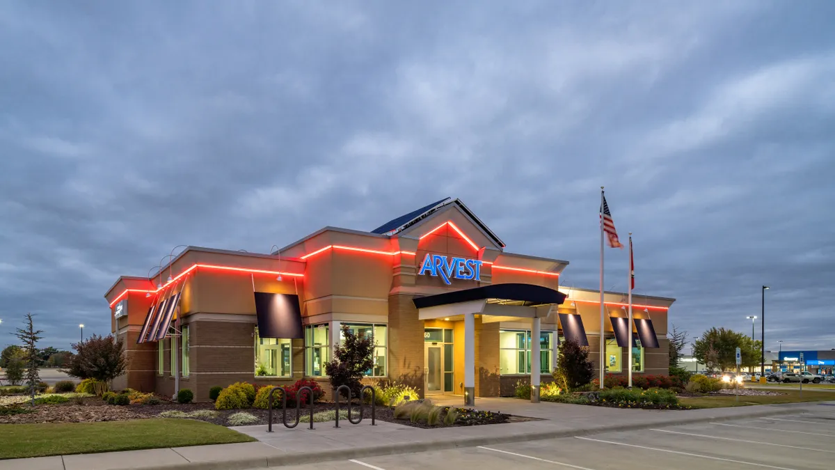 An Arvest Bank branch building pictured at sunset.