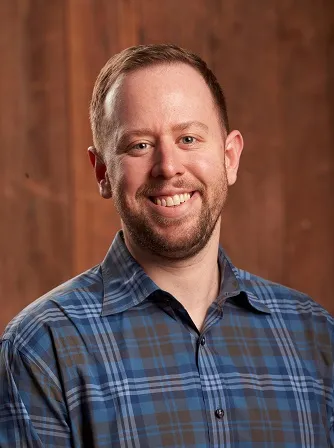 John Evons smiling for a portrait.