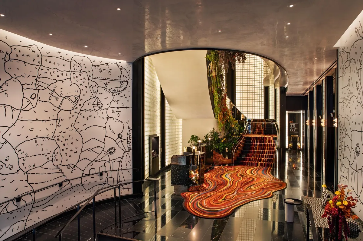 The lobby features an orange carpet with a modern design.