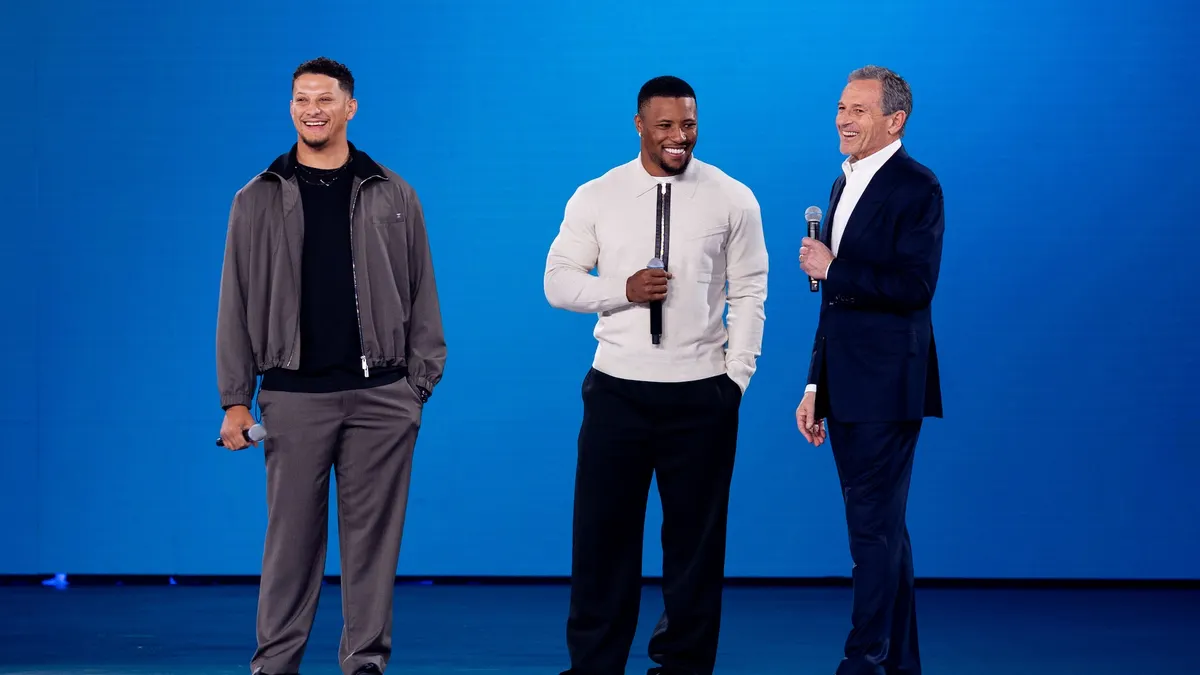 Patrick Mahomes and Saquon Barkley with Disney CEO Bob Iger