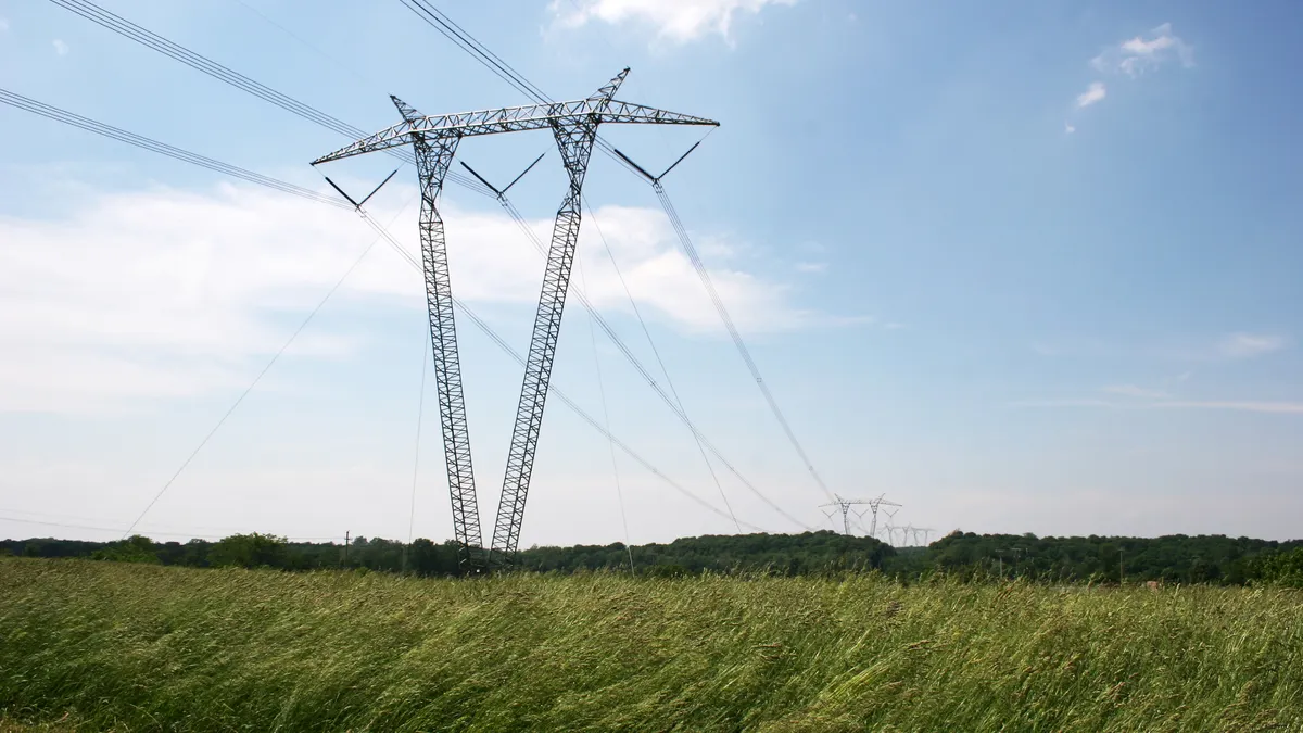 An electric power line crosses a field.