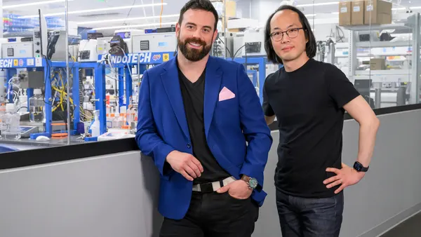 Strand Therapeutics co-founders Jake Becraft and Tasuku Kitada pose in a laboratory setting.