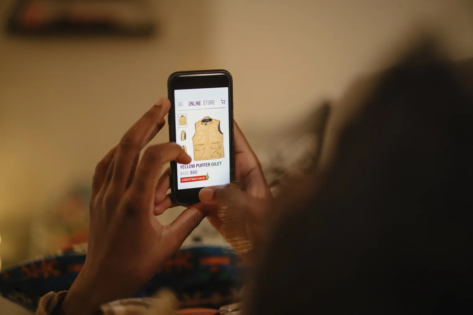 A person holds a mobile phone with a screen that has a vest on it.