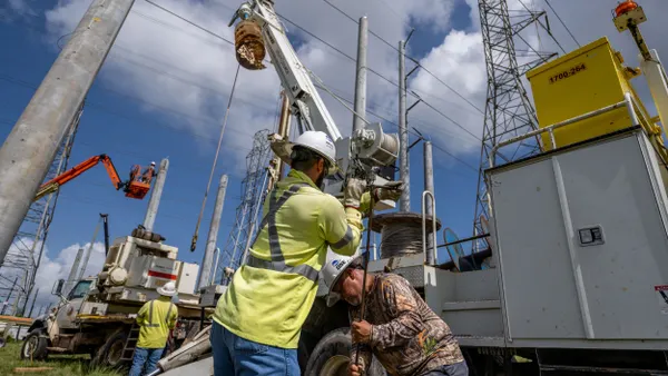 Service technicians work to install transmission towers.