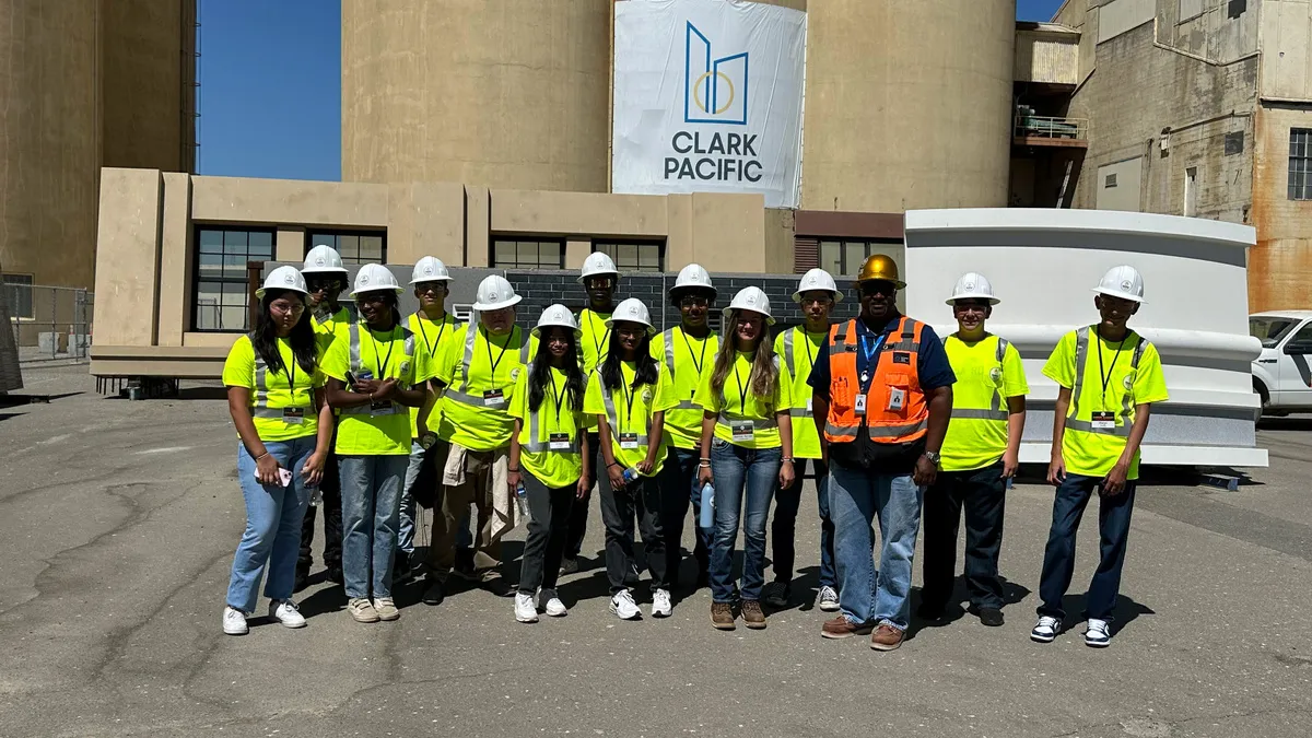 A group of people in construction gear pose for a photograph.