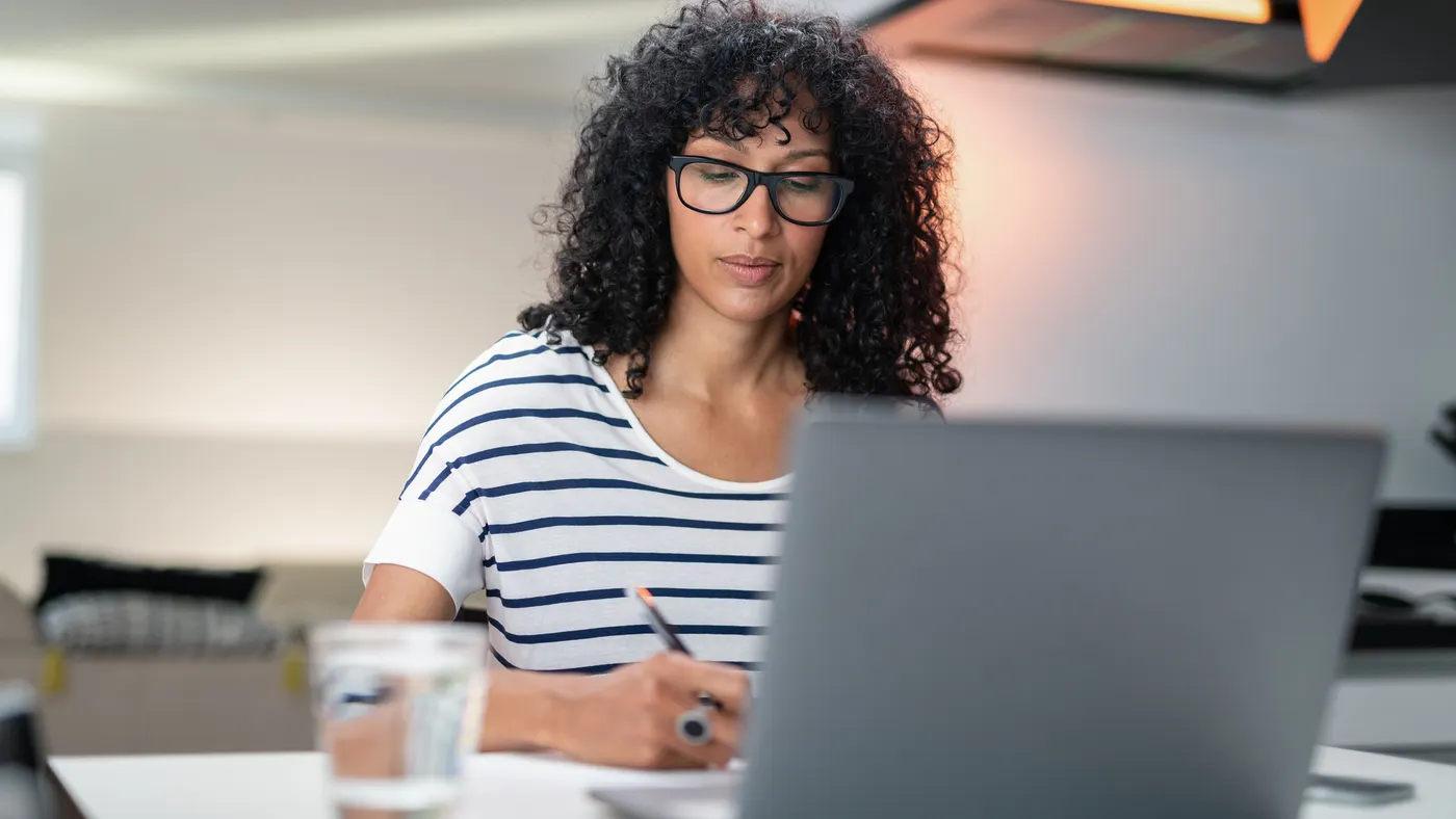 Remote working from home. Freelancer workplace in kitchen, living room with laptop.Concept of distance learning, isolation, female business, shopping online.