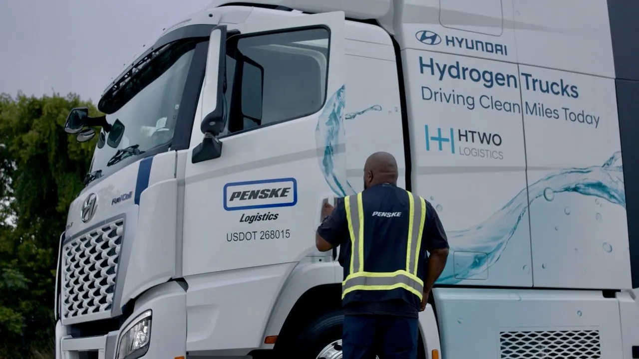 A Penske Logistics driver outside a hydrogen fuel cell truck.