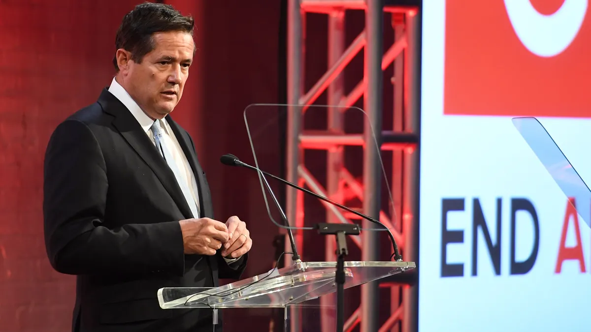 jes staley at a podium as a conference speaking