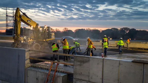 A group of construction workers on a roadway.