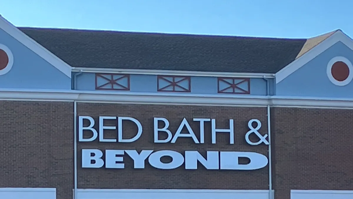 A Bed Bath & Beyond sign on a brick facade with clear blue sky