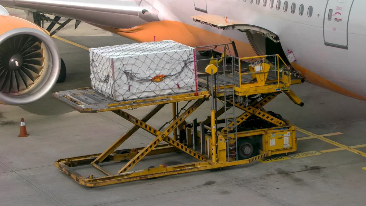 Cargo is loaded into the belly of a passenger aircraft