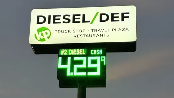 A photo of a fuel sign that says "diesel/def truck stop, travel plaza, restaurants, #2 diesel cash $4.29.9.