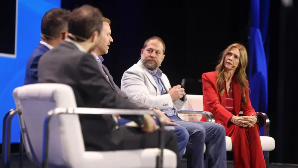 people on stage in a panel