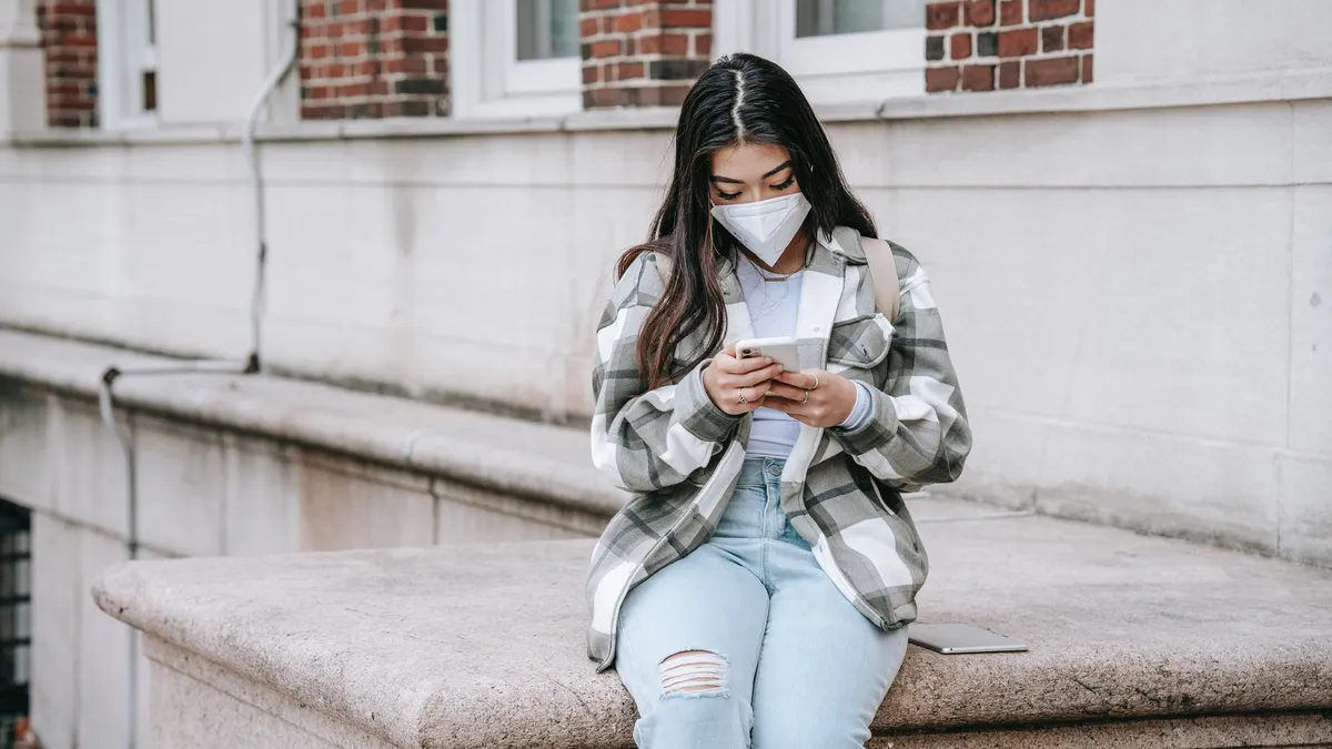 College student uses a cell phone on campus