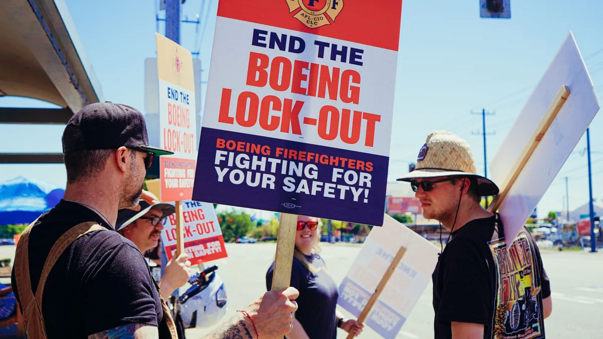 People holding "End the Boeing lockout" outside.