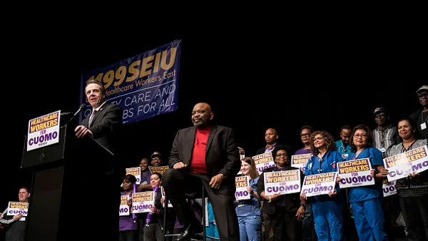 New York Governor Andrew Cuomo speaks as 1199SEIU United Healthcare Workers East President George Gresham looks on at a healthcare union rally at the Theater at Madison Square Garden, February 21, 2018 in New York City. The rally was organized by 1199SEIU United Healthcare Workers East, the largest healthcare union in the United States.