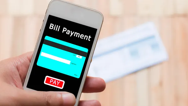 Hand holding a mobile phone with image of a credit card that says Bill Payment and has a red Pay button.