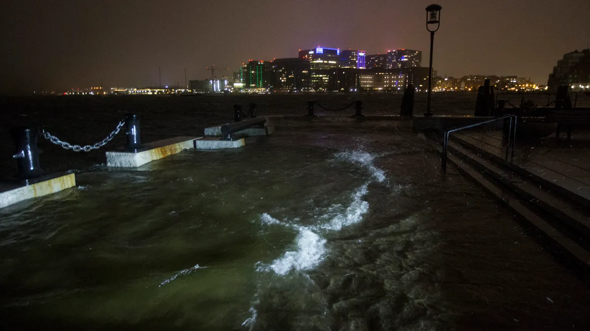 Flooding along a developed coast at night with city in the background