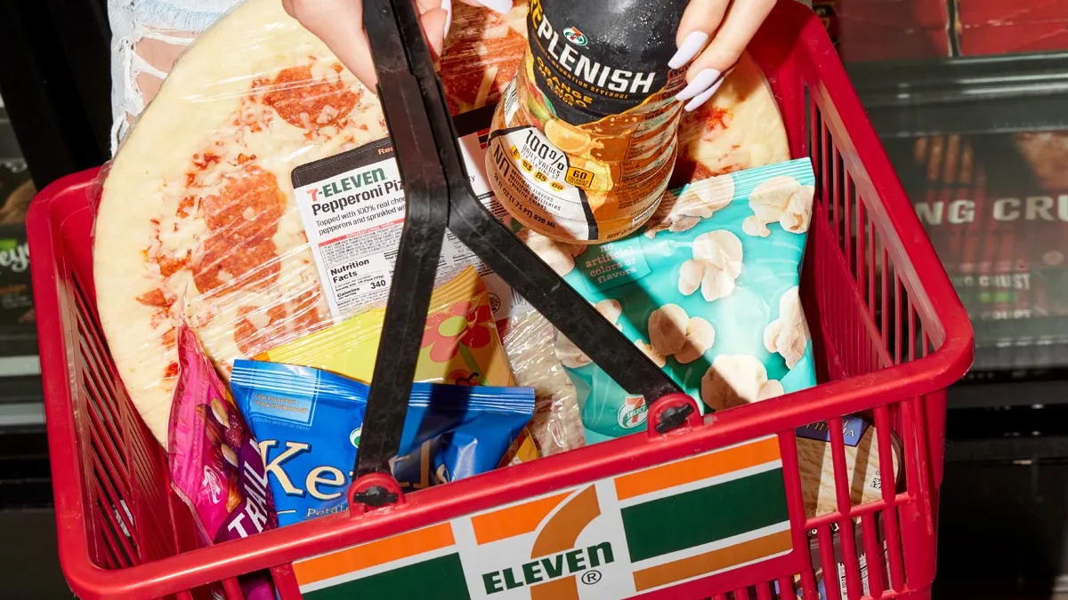 A photo of a shopping basket of items, many of them with 7-Eleven branding.