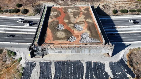 An aerial view of construction of the Wallis Annenberg Wildlife Crossing