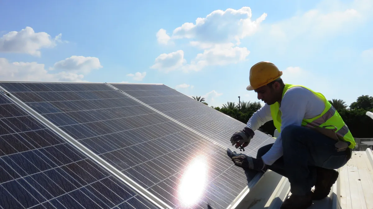 A person installing solar panels.