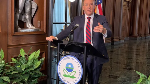 A man speaks at a podium