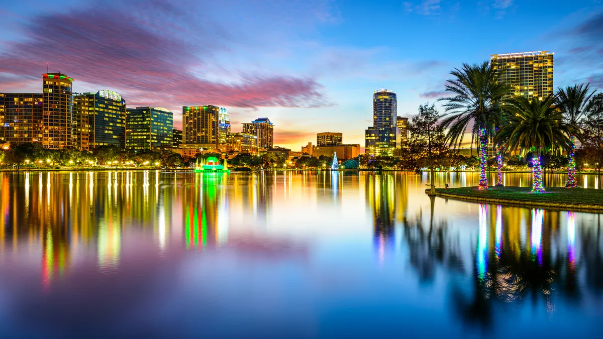 The downtown Orlando skyline at night as viewed from Eola Lake.