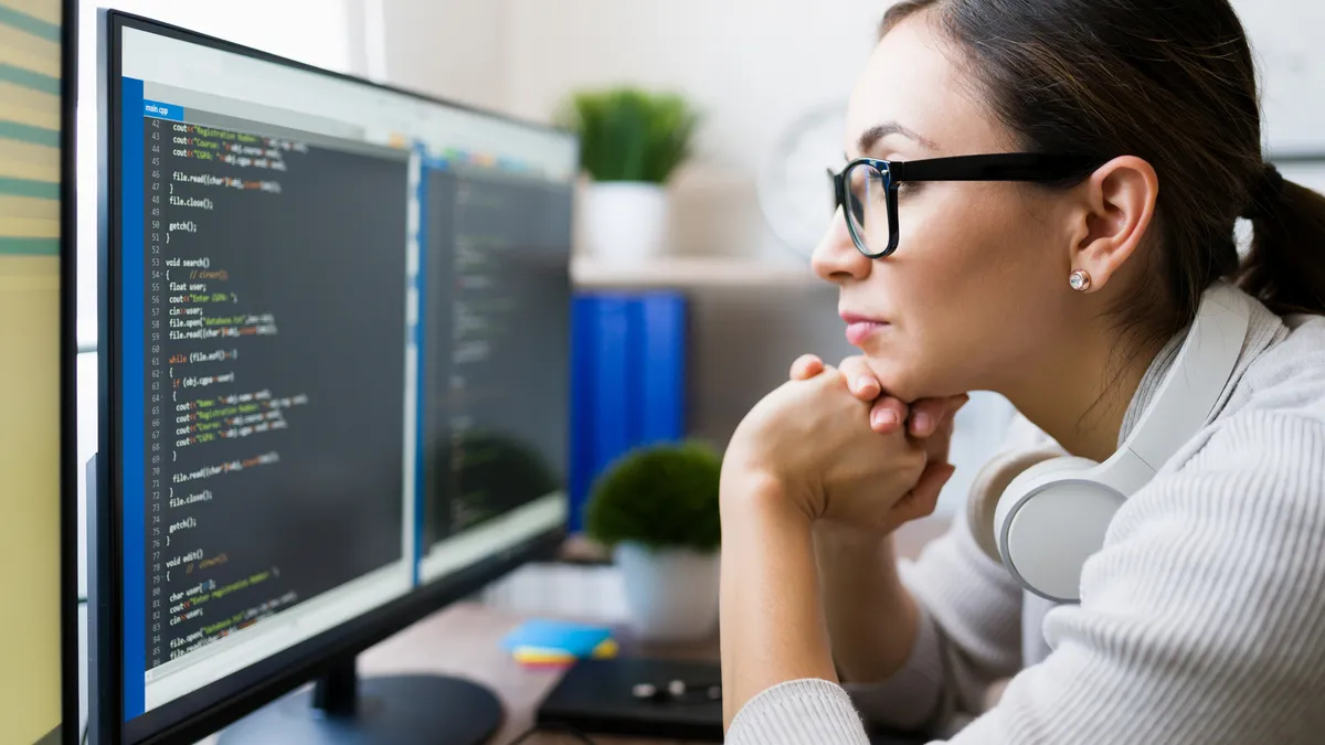 A woman reviewing code.