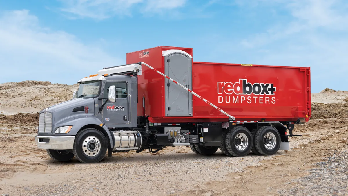 Truck with red dumpster on back