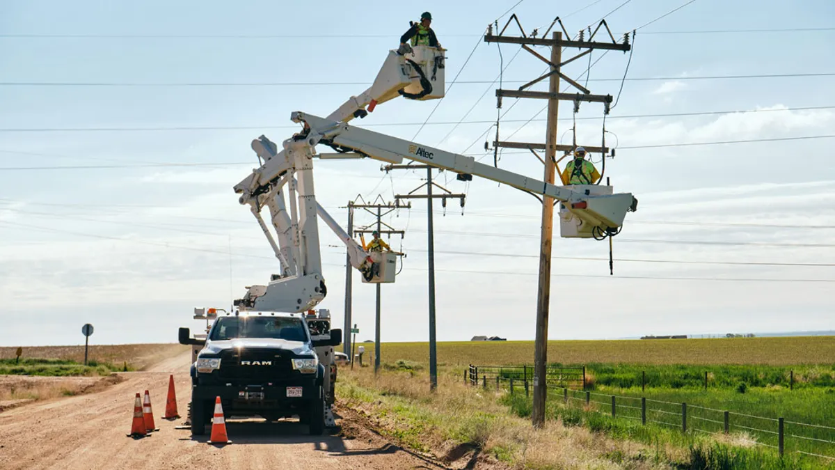 Electrician in bucket making repairs to electric pole lines