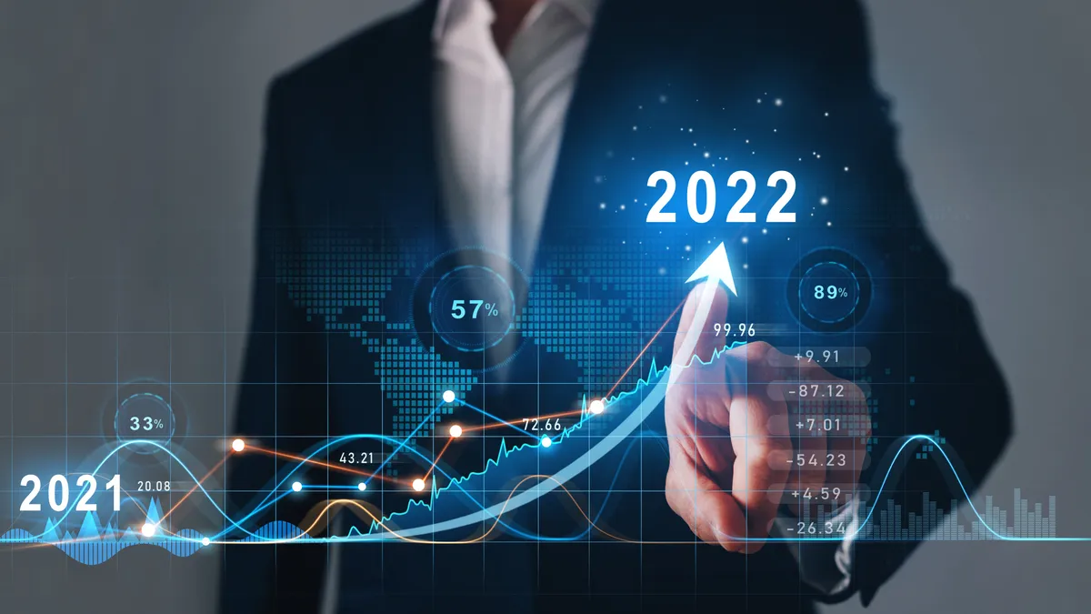 Businessman draws increase arrow graph corporate future growth year 2021 to 2022. Development to success and motivation.