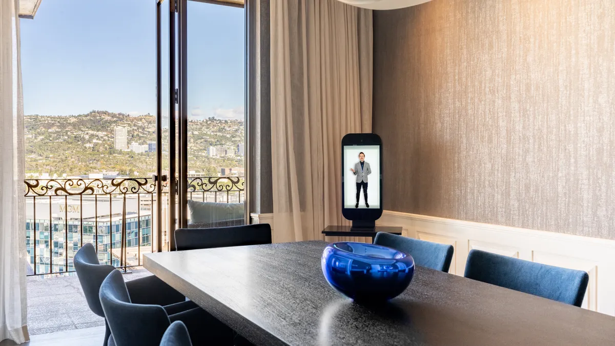 A holographic concierge in a meeting room.